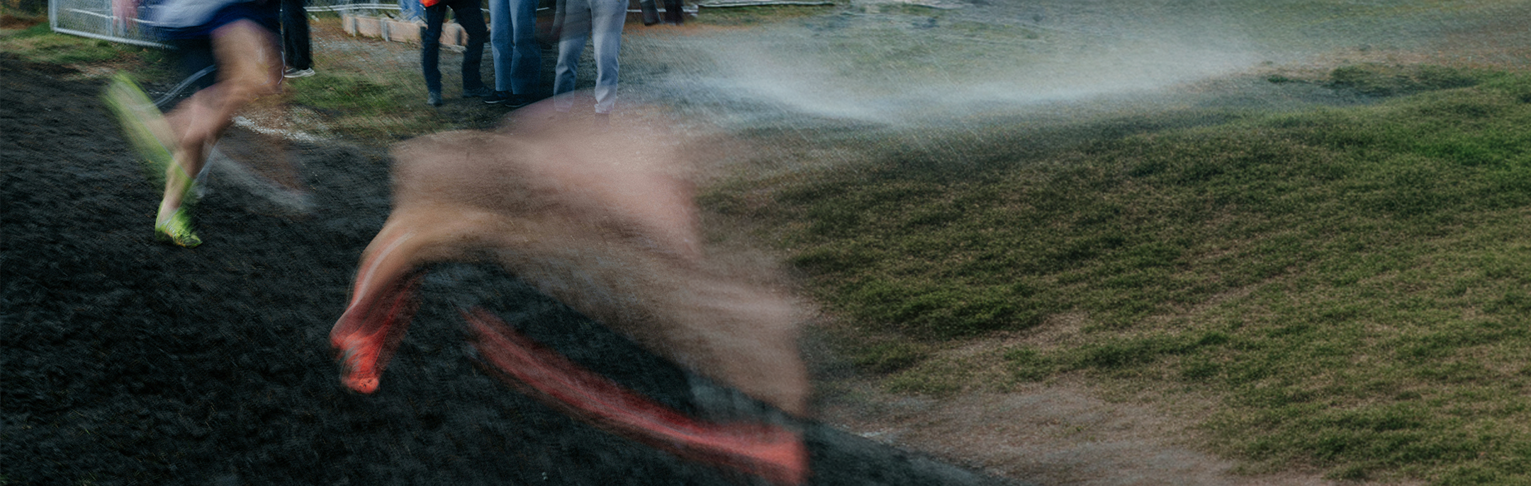 Person running on a muddy path with water splashing around